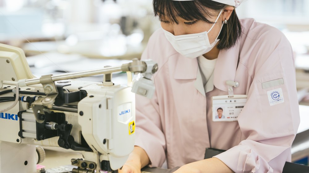 自分のミシンで園児服を縫い上げる職人
